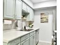Charming kitchen featuring stainless steel appliances and light green cabinetry at 286 W Palomino Dr # 78, Chandler, AZ 85225