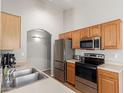 Functional kitchen with stainless steel appliances, oak cabinets, and ample counter space at 29151 N Lilly Ln, San Tan Valley, AZ 85143
