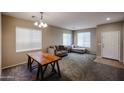 Inviting living room with neutral walls, plush carpet, and natural light from several bright windows at 2934 W Peggy Dr, San Tan Valley, AZ 85144
