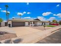 Spacious home with a large driveway, low-maintenance landscaping, and a two-car garage at 3008 S Saguaro Cir, Mesa, AZ 85202