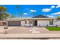 Well-maintained single-story home with desert landscaping and modern design elements at 3008 S Saguaro Cir, Mesa, AZ 85202
