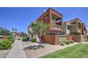 Stunning multi-story condo featuring desert landscaping, a private balcony, and a well-manicured lawn at 3600 N Hayden Rd # 2310, Scottsdale, AZ 85251