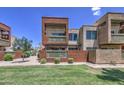 Beautiful condo with a modern design, manicured lawn, and a cozy balcony for outdoor living at 3600 N Hayden Rd # 2310, Scottsdale, AZ 85251
