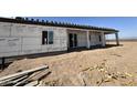 View of the back side of a home under construction showing windows and a sliding glass door at 37459 W Missouri Ave, Tonopah, AZ 85354
