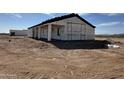 Side view of a new build house showing the building wrap and framed windows at 37459 W Missouri Ave, Tonopah, AZ 85354