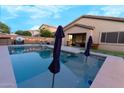 Backyard pool with sun loungers, privacy fencing, and artificial grass at 4064 E Reins Rd, Gilbert, AZ 85297