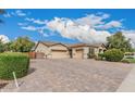 Spacious three-car garage and large paver driveway, providing ample parking space at 4318 N 180Th Dr, Goodyear, AZ 85395