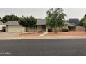 Charming single-story home featuring a well-maintained lawn and a spacious two-car garage at 4329 W Bloomfield Rd, Glendale, AZ 85304