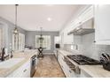 Spacious kitchen with island, stainless steel appliances, granite countertops, and chandelier lighting at 4453 S Huachuca Way, Chandler, AZ 85249