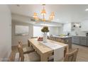 Bright dining room featuring a large table, stylish chairs, and a view of the kitchen at 5132 N 83Rd St, Scottsdale, AZ 85250