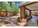 Private outdoor patio with brick features and mature landscaping at 5144 W Sweetwater Ave, Glendale, AZ 85304