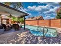 Backyard swimming pool with covered patio and seating area at 5144 W Sweetwater Ave, Glendale, AZ 85304