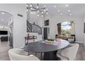 Dining area features a modern table, chairs and views of the staircase at 6449 E Paradise Ln, Scottsdale, AZ 85254