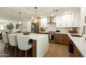 Modern kitchen featuring white and brown cabinetry, stainless steel appliances, and a spacious island with seating at 7618 N Via Del Paraiso --, Scottsdale, AZ 85258