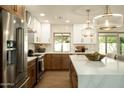 Bright kitchen showcasing stainless steel appliances, stylish pendant lighting, and a breakfast bar with comfortable seating at 7618 N Via Del Paraiso --, Scottsdale, AZ 85258