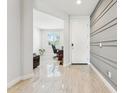 Bright foyer with ceramic tile flooring, decorative wall trim and views into the front office at 8754 W San Juan Ave, Glendale, AZ 85305