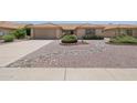 Well maintained single-story home featuring desert landscaping, a two-car garage, and a tile roof at 9263 W Oraibi Dr, Peoria, AZ 85382