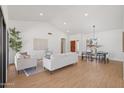 Bright and airy living room featuring vaulted ceilings, modern furniture, and hardwood floors at 9263 W Oraibi Dr, Peoria, AZ 85382
