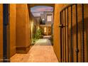 Elegant entrance through a decorative gate leading to the front door of this stylish home at 9270 E Thompson Peak Pkwy # 347, Scottsdale, AZ 85255