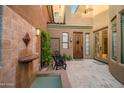 Cozy courtyard featuring tiled fountain, quaint seating area, and lovely exterior lighting at 9270 E Thompson Peak Pkwy # 347, Scottsdale, AZ 85255