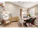 Bright dining area features a dining table, accent chair and sliding glass door to the backyard at 9624 E Thunderbolt Ave, Mesa, AZ 85212