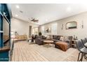 Spacious living room features wood-look tile flooring, a comfortable seating area, and natural light at 9624 E Thunderbolt Ave, Mesa, AZ 85212