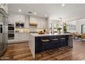 Modern kitchen featuring white cabinets, stainless steel appliances, and a large central island at 9904 E South Bend Dr, Scottsdale, AZ 85255