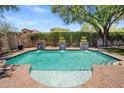 Inviting pool with decorative fountain features and lush landscaping for added privacy at 9904 E South Bend Dr, Scottsdale, AZ 85255