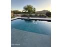 Relaxing backyard pool with clean water, a water feature, and decorative landscaping at 1100 S 176Th Ave, Goodyear, AZ 85338