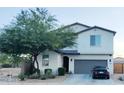 Charming two-story home boasts a well-manicured front yard and an attached two-car garage at 1100 S 176Th Ave, Goodyear, AZ 85338