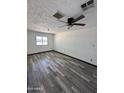 Bedroom features modern ceiling fan, laminate flooring, fresh paint, and ample natural light at 1214 E Henry St, Tempe, AZ 85288