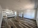 Open-concept living room and kitchen boasts modern laminate flooring and abundant natural light at 1214 E Henry St, Tempe, AZ 85288