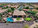 Aerial view of a home featuring a private pool, putting green, and covered patio area at 13072 W Alyssa Ln, Peoria, AZ 85383