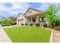 Attractive curb appeal of this single-Gathering home showcasing desert landscaping and a welcoming front porch at 14360 W Windrose Dr, Surprise, AZ 85379