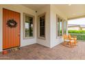 Cozy front porch with a sitting area, perfect for enjoying the outdoors and neighborhood views at 14360 W Windrose Dr, Surprise, AZ 85379