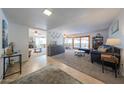 Bright living room with stylish furniture, neutral paint colors, and connecting dining and fireplace spaces at 14412 N 39Th Ave, Phoenix, AZ 85053