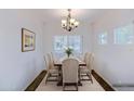 Bright dining room features a wood table, chandelier, decorative rug, and six upholstered chairs at 1453 W Birch Rd, San Tan Valley, AZ 85140