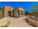 Inviting front entrance with a landscaped walkway and covered porch, showcasing the home's curb appeal at 16704 W Oracle Rim Dr, Surprise, AZ 85387