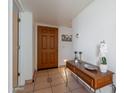 Inviting foyer with tile floors, wooden door, and a charming accent table at 16715 E El Lago Blvd # 212, Fountain Hills, AZ 85268