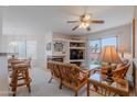 Bright living room featuring a fireplace, built-in shelves, and sliding glass doors at 16715 E El Lago Blvd # 212, Fountain Hills, AZ 85268