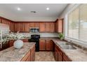A kitchen featuring rich wood cabinets, stainless steel appliances, and a functional center island at 21039 E Avenida Del Valle --, Queen Creek, AZ 85142