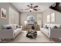 Cozy living room with neutral tones, comfortable sofas, and a stylish ceiling fan at 21039 E Avenida Del Valle --, Queen Creek, AZ 85142