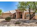 Charming single-story home with a tile roof, desert landscaping, and an arched entryway at 2226 N Gentry --, Mesa, AZ 85213