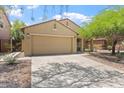 Inviting single-story home with a two-car garage, well-maintained landscaping, and a welcoming entrance at 23787 W Yavapai St, Buckeye, AZ 85326