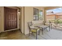 Cozy front porch with seating, offering a relaxing spot to enjoy the neighborhood views at 23787 W Yavapai St, Buckeye, AZ 85326