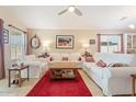 Bright living room featuring tile floors, comfortable seating, and large windows for natural light at 23787 W Yavapai St, Buckeye, AZ 85326