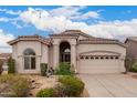 Exterior elevation of a stucco home with a tile roof, arched entry, and desert landscaping at 3055 N Red Mtn # 77, Mesa, AZ 85207