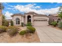 Front exterior of a stucco home, featuring a tile roof, desert landscaping, and attached garage at 3055 N Red Mtn # 77, Mesa, AZ 85207
