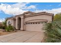 Close up of front of stucco home with tile roof, desert landscaping, and attached garage at 3055 N Red Mtn # 77, Mesa, AZ 85207