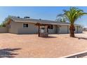 Backyard view of this charming single-story home, featuring decorative well and desert landscaping at 350 N 88Th St, Mesa, AZ 85207
